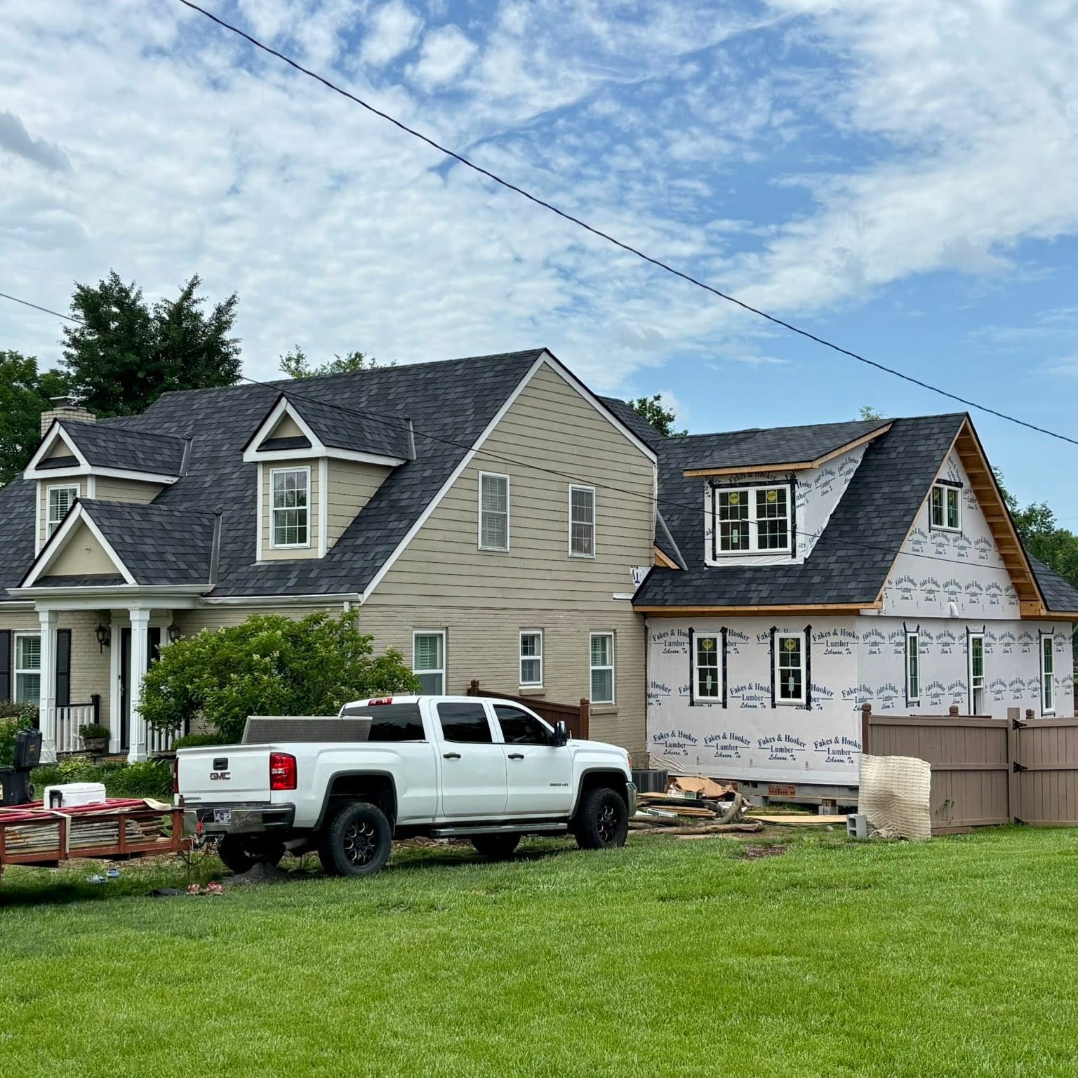 Two-story home addition with new roof and wrapped exterior walls